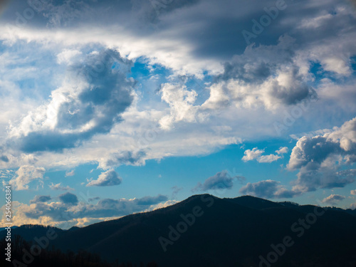 Beautiful landscape in the mountains at sunset. View of colorful sky with amazing clouds.