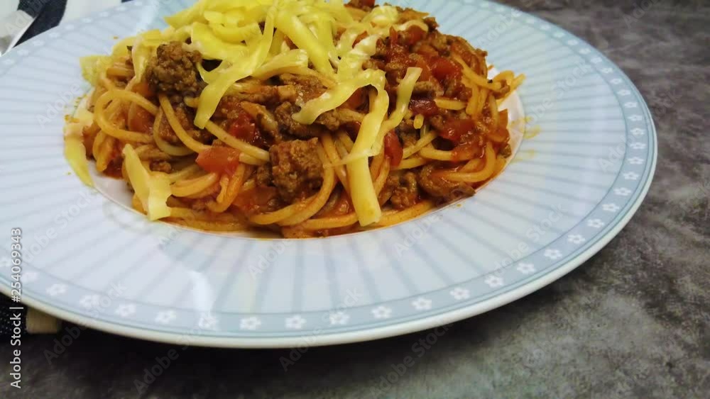 4K video plate with spaghetti with Bolognese sauce and cheese. it's on a wooden table background. 4K video plate with spaghetti with Bolognese sauce and cheese. it's on a wooden table background.