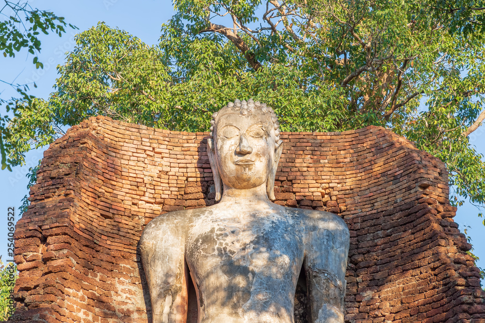 Standing Buddha statue at Wat Phra Si Ariyabot temple in Kamphaeng Phet Historical Park, UNESCO World Heritage site