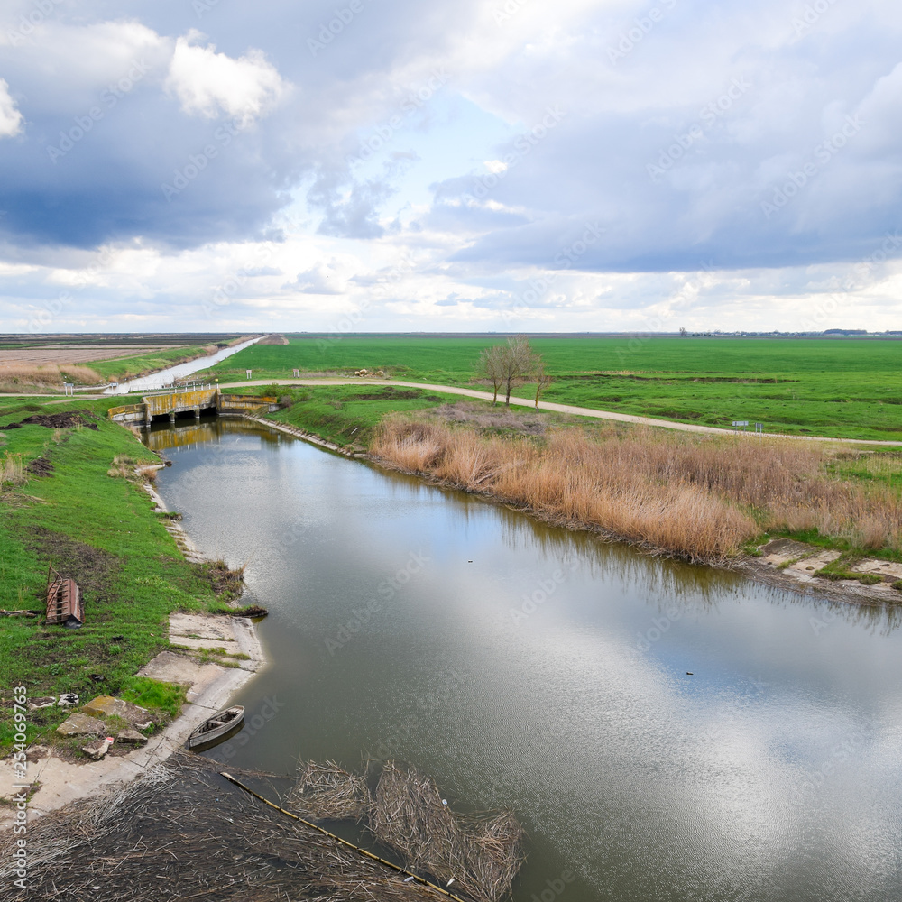 Bridges through irrigation canals. Rice field irrigation system Bridges through irrigation canals. Rice field irrigation system