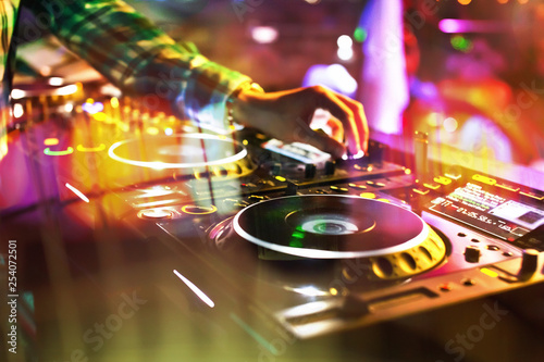 Dj mixes the track in the nightclub at party.  Sound and music equipment.