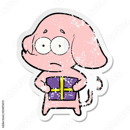 distressed sticker of a cartoon unsure elephant with christmas present