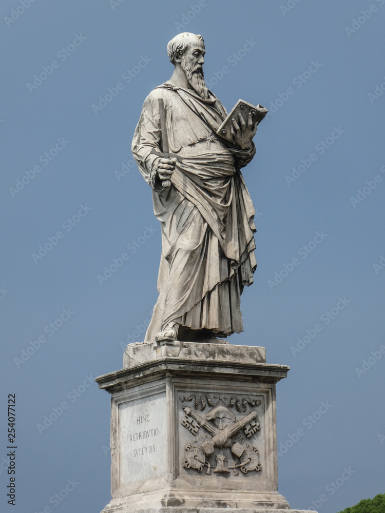 Statue of the apostle St. Paul holding a broken sword and a book with the pedestal inscription Borgo, on Ponte Sant'Angelo, Rome, Italy. The sculpture was by the Italian early Renaissance Paolo Romano