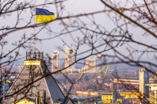 Early spring at sunny evening in warm weather. Industrial zone and residential areas Podin and northern suburbs Obolon in Kyiv on the right bank of the Dnipro River. Ukraine Mar. 6, 2019 photo