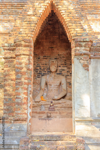 Sitting Buddha statue in chamber at Wat Sing temple in Kamphaeng Phet Historical Park, UNESCO World Heritage site