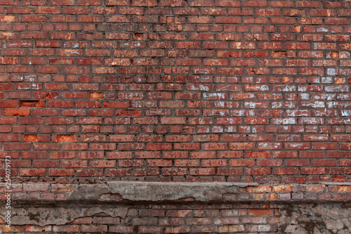 Old brick wall with scratches  cracks  dust  crevices  roughness. Can be used as a poster or background for design.