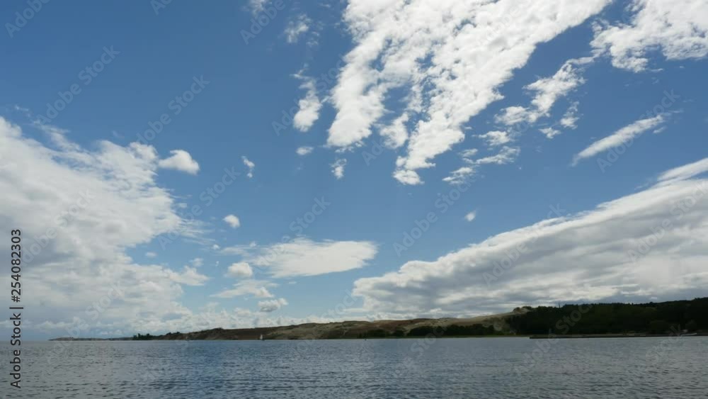 Nida, Curonian Spit, Lithuania. Parnidis dunes and small yacht in a curonian lagoon. Time lapse. Nida, Curonian Spit, Lithuania. Parnidis dunes and small yacht in a curonian lagoon. Time lapse.
