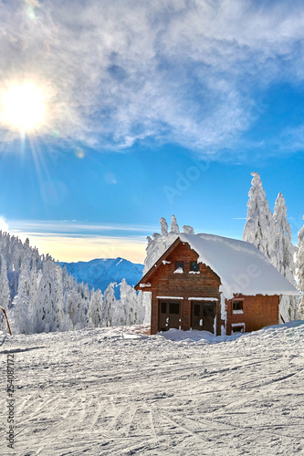 Panoramic view over the ski slope, ski resort in Transylvania, Pine forest covered in snow on winter season,Mountain landscape in winter,Poiana Brasov, Romania