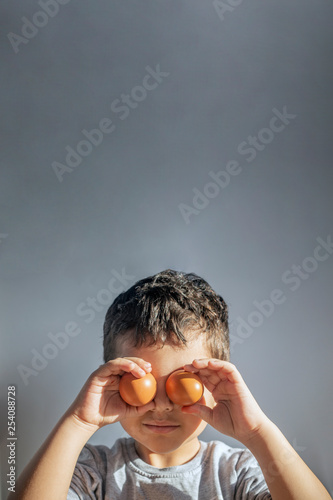 A boy painting Easter eggs. Happy Easter. Son painting Easter eggs. © Golib Tolibov