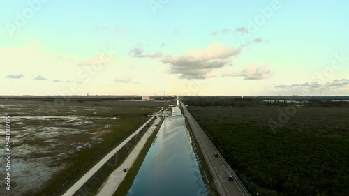 Wallpaper Mural Aerial Drone Footage of  Flight above a road and swamps with calm Water and forest in a cloudy sunset with beautiful soft light and a magestic landscape view. Torontodigital.ca