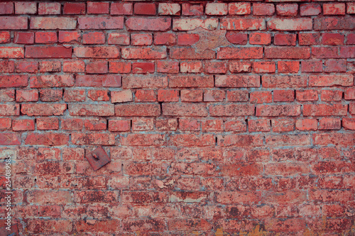 Old brick wall with scratches, cracks, dust, crevices, roughness. Can be used as a poster or background for design.