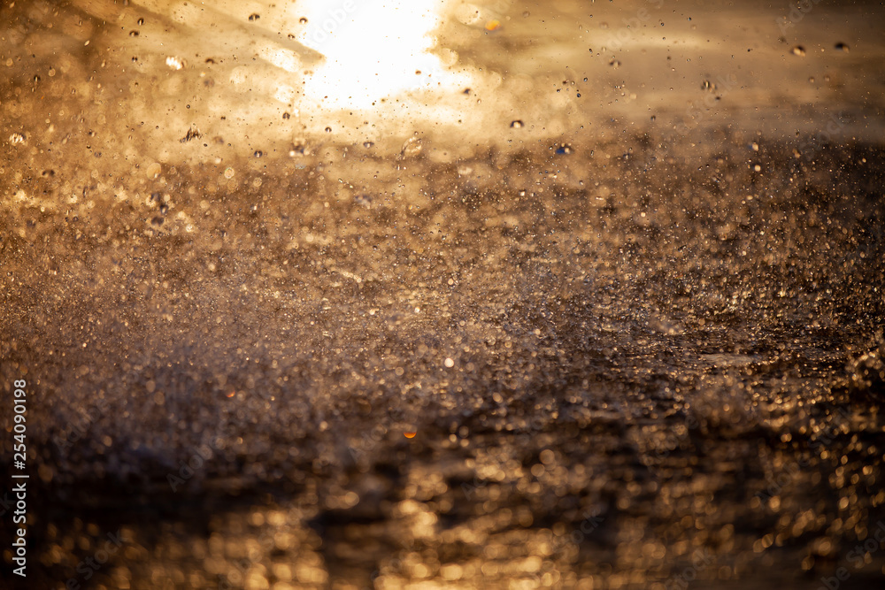 Splashes of water and bokeh of Water on a Sunset Background. Splashes of water and bokeh of Water on a Sunset Background.