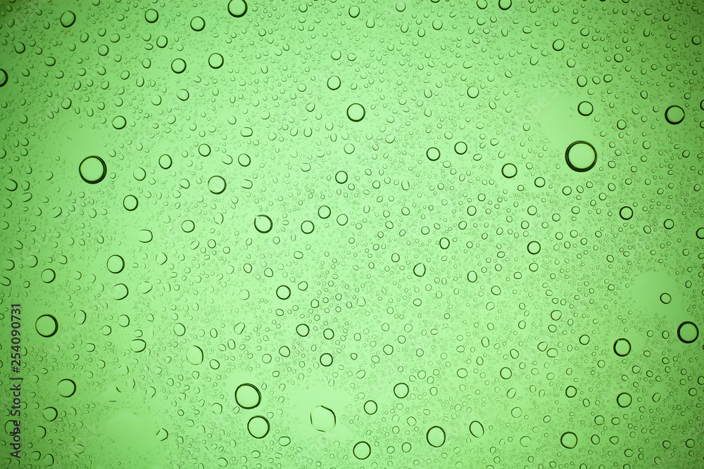 Rain droplets on green glass background, Water drops on green glass.