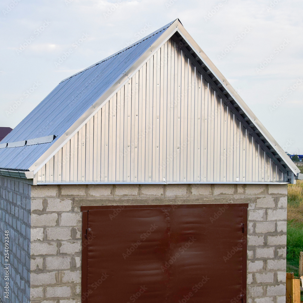 Small garage with a roof of corrugated sheet metal