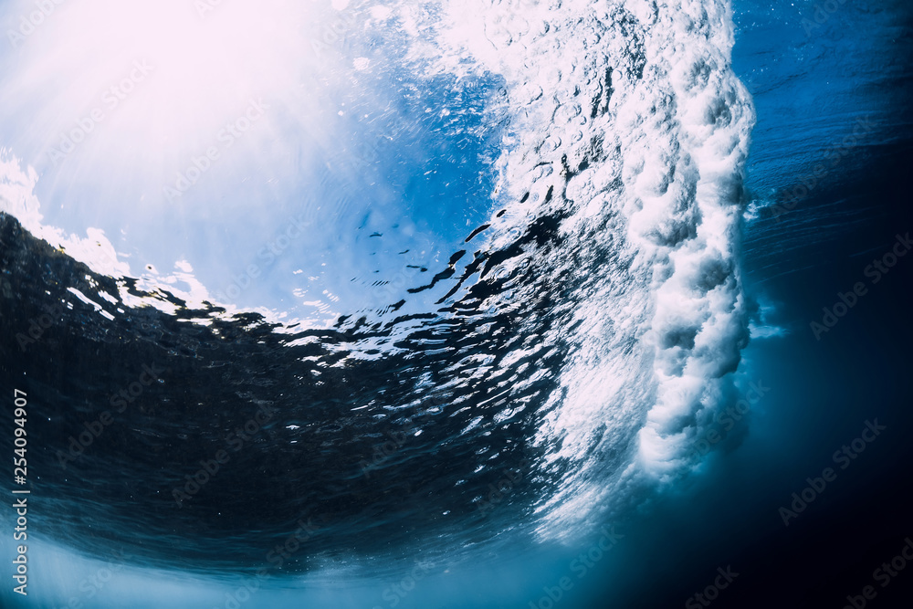 Powerful wave underwater with air bubbles. Ocean in underwater