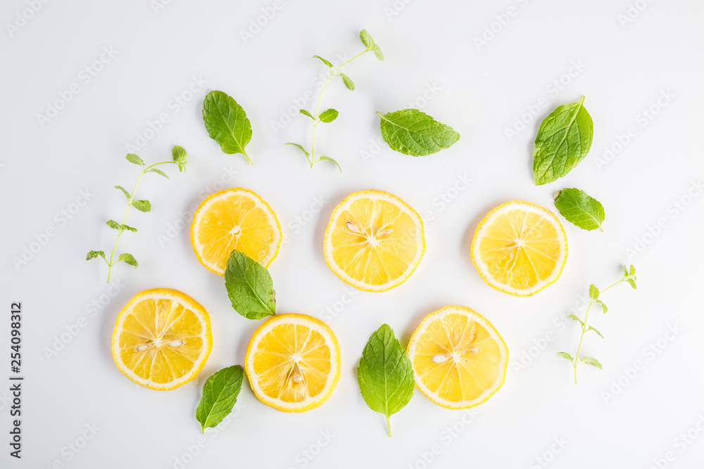 Lemon slices and mint leaves on white background Lemon slices and mint leaves on white background