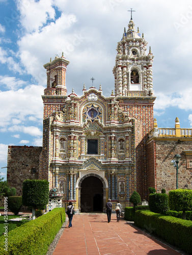 The Temple of San Francisco Acatepec is a religious monument typical of the Mexican baroque architecture, with Its facade of talavera tiles and red bricks, Cholula, Puebla, Mexico. photo