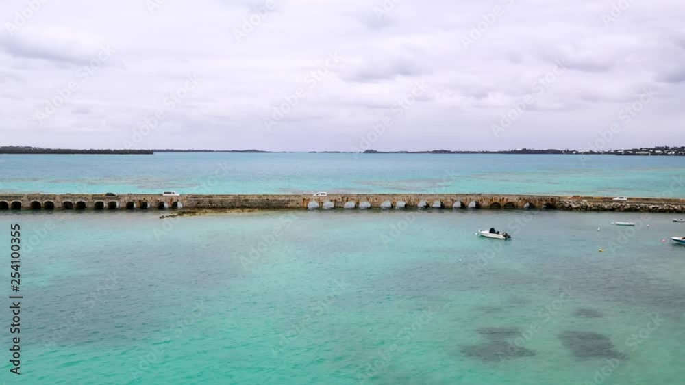 Aerial view of car bridge over turquoise water on tropical island. MOVING FORWARD.