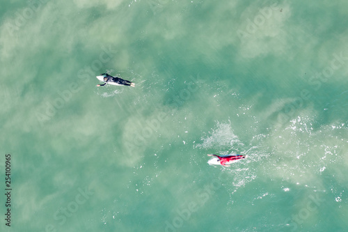 Aerial view of two surfers at famous Bell's beach in Victoria, Australia photo