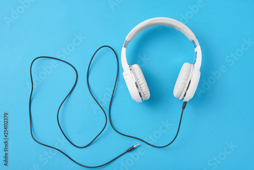 White headphones on a pastel blue background
