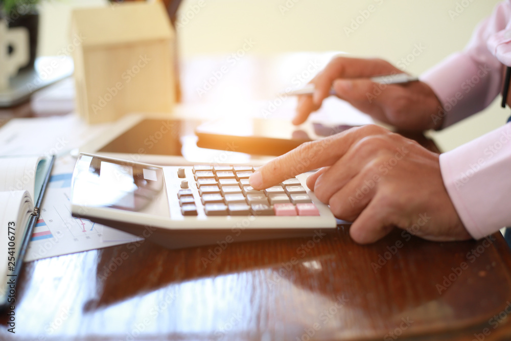 Hand man doing calculate and thinking on desk about tax at home office. Hand man doing calculate and thinking on desk about tax at home office.