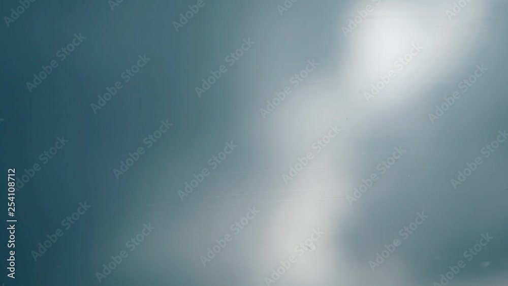 close view black wiper cleans raindrops from wet car windshield quickly against white blurred silhouette close view black wiper cleans raindrops from wet car windshield quickly against white blurred silhouette