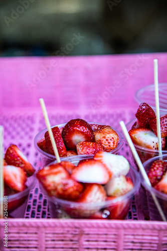 Strawberries in plastic glass photo