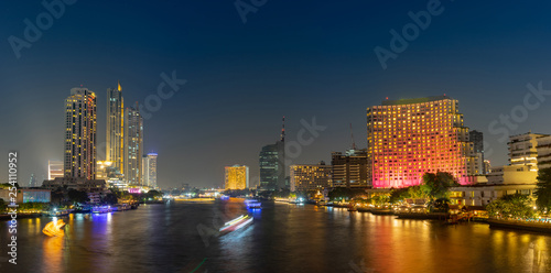 Cityscape riverfront with long exposure light on the bridge. Bangkok  Thailand. Panorama