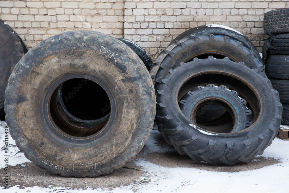 Big black tires in industrial park. Black rubber. Travel urban photo 2019.