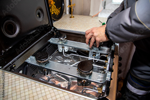 MINSK, BELARUS - 18 FEBRUARY, 2019: gas worker checks the gas stove