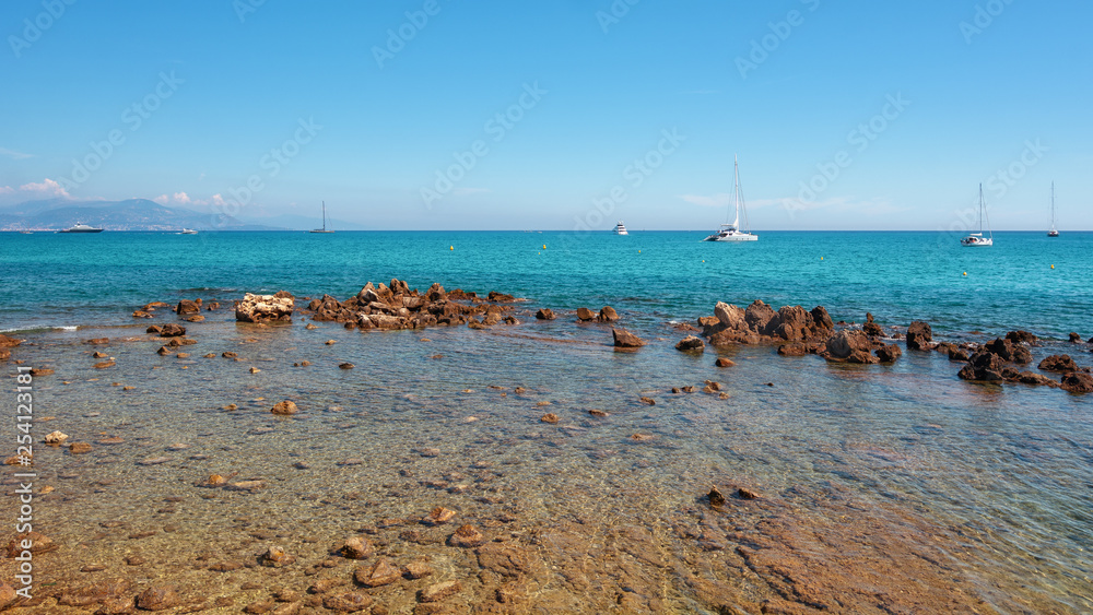 Motor boats and sailboats at anchor offshore the coast of Antibes