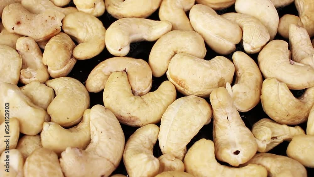Cashew nuts closeup texture video on rolling rotating looping plate Cashew nuts closeup texture video on rolling rotating looping plate