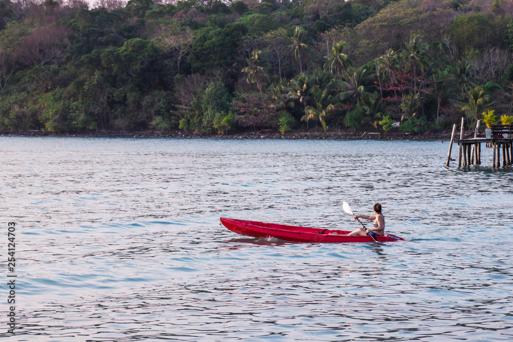Women tourists wear bikini set kayaking in sea beautiful area ao bang bao at Koh Kood island Trat, Thailand.