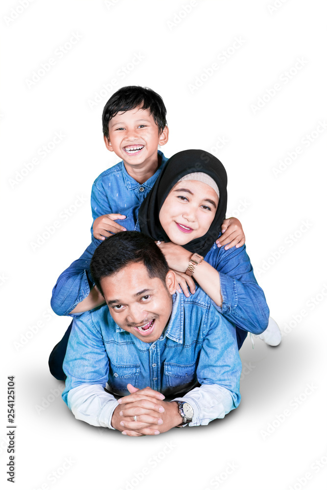 Parents cuddling in the studio with their son Parents cuddling in the studio with their son
