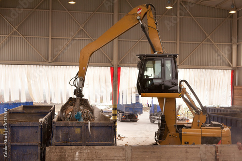 The grab takes the rubbish and move it to the incinerator where all waste is burned. Grab taking waste for burning it in the incinerator. Huge amount of dirty refuse going to be processed.