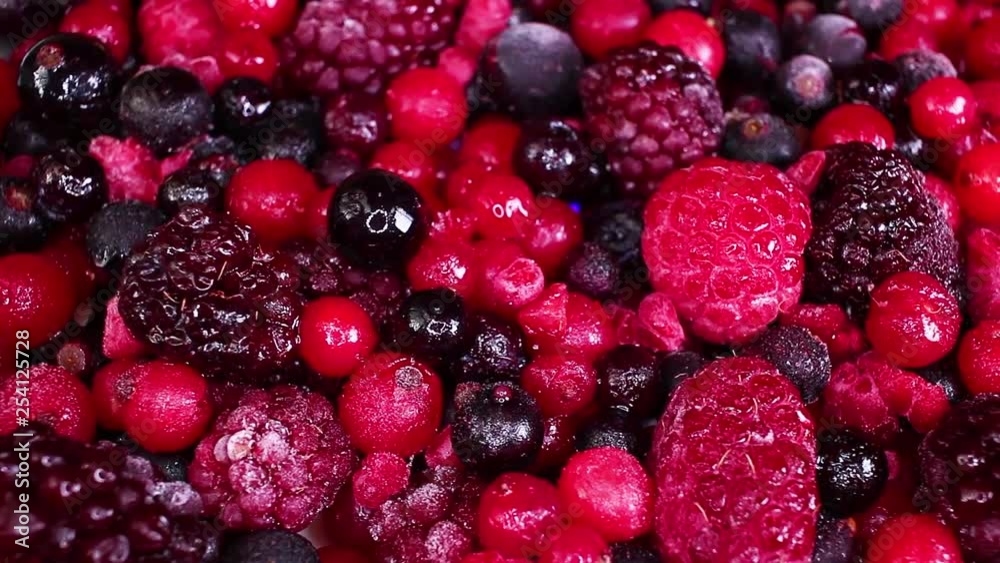 Berry fruit mix blueberry blackberry mulberry closeup texture video on rolling rotating looping plate