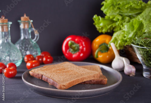 Sliced Toast Bread on black plate with vegetables