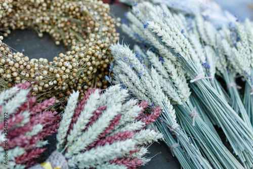 Traditional bouquets of ripe cereal wheat, linen, field grass. Vintage harvest background, copy space.