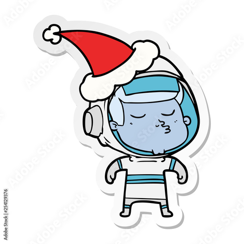 sticker cartoon of a confident astronaut wearing santa hat