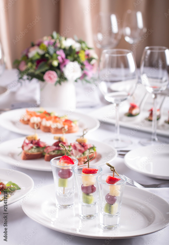 Beautifully decorated Banquet table with snacks, canapes, sandwiches, fresh vegetables, birthday, corporate event or wedding celebration