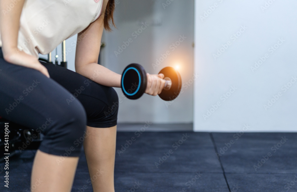 Woman exercise workout in gym fitness.concept of healthy.athlete builder muscles lifestyle.Exercise program to reduce weight of woman Woman exercise workout in gym fitness.concept of healthy.athlete builder muscles lifestyle.Exercise program to reduce weight of woman