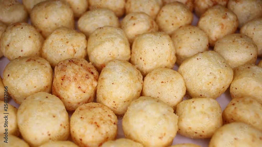Millet ball gluten free balls closeup texture video on rolling rotating looping plate Millet ball gluten free balls closeup texture video on rolling rotating looping plate