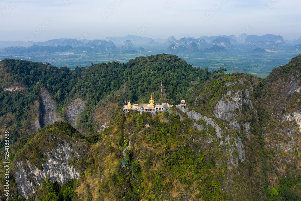 View from above, stunning aerial view of the beautiful Tiger Cave Temple (Wat Tham Sua) surrounded by amazing ridges of limestone mountains. 