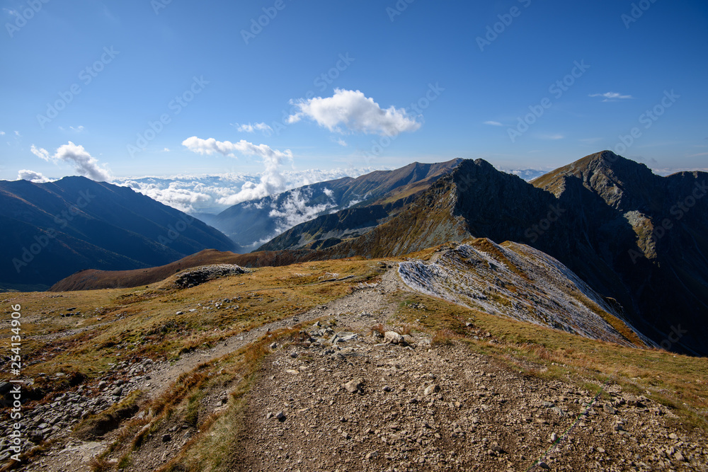 Tatra mountain peaks with tourist hiking trails in sunny summer day