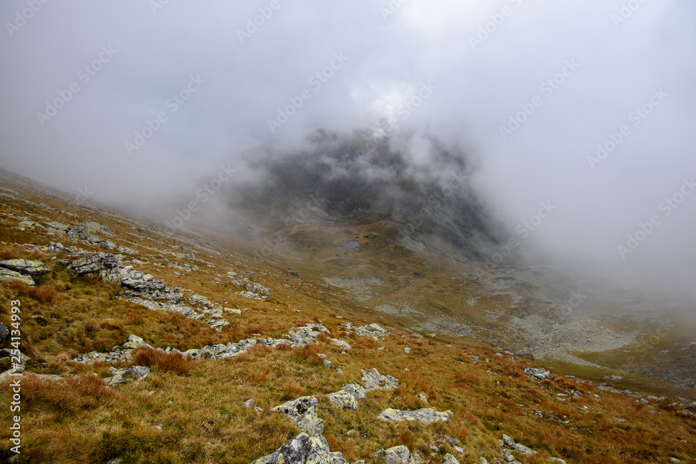 Tatra mountain peaks with tourist hiking trails in sunny summer day