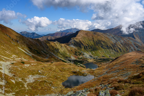 Tatra mountain peaks with tourist hiking trails in sunny summer day