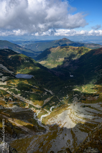 Tatra mountain peaks with tourist hiking trails in sunny summer day