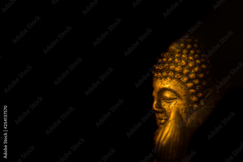 bronze colored idol of lord buddha