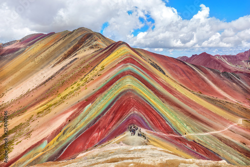Unidentified  tourists walking on the Rainbow Mountain, Peru.