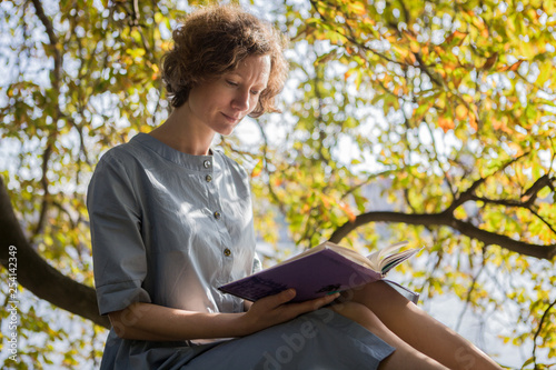 Woman sitting in the park and reading a book